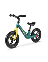 Green and yellow balance bike on a white background