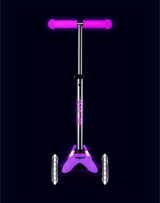 Purple scooter with pink handlebars on a black background