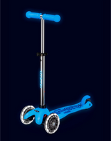 Blue scooter with glowing wheels on a black background