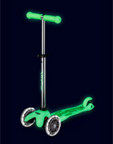 Green scooter with glowing handlebars on a black background