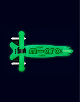 Green mini micro scooter on a black background