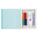Stationery set with colorful pencils, stickers, and a pen in a white frame on a light blue polka dot background.