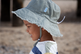 Side view of child wearing a khaki bucket hat