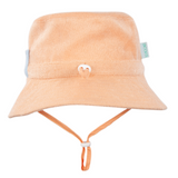 Peach bucket hat with a strap on a white background