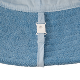 Close-up of a blue fabric with a white buckle on a white background