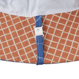 Close-up of a fabric with a blue strap and white buckle, featuring an orange and white checkered pattern.