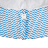 Close-up of a blue and white patterned fabric with a button on a white background