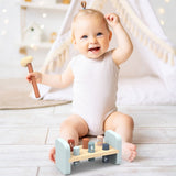 Baby sitting on floor playing with SPEEDY MONKEY Hammer Bench