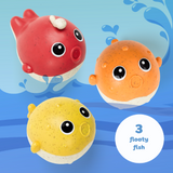 Three colorful fish toys on a blue background with water splashes.