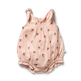 Pink baby romper with strawberry pattern on a white background