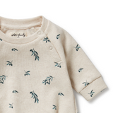 Detailed view of neck opening & knit on WILSON & FRENCHY Little Olive Organic Waffle Bodysuit