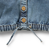 Detail view of tied waistband and wooden buttons