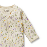 Detailed view of zip covered neck opening on WILSON & FRENCHY Bella Floral Organic Zipsuit With Feet