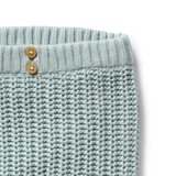 Detail view of waistband and knit and wooden buttons