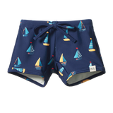 Navy blue shorts with sailboat pattern on a white background