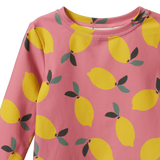 Pink rash top with yellow lemon pattern on a white background