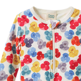 Detail view of baby swimsuit with colourful floral pattern on a white background