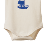 Beige baby onesie with a blue sailboat design on a white background