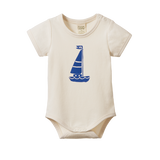 Beige baby onesie with blue sailboat design on a white background