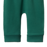 Green baby pants with rolled cuffs on a white background
