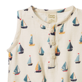 Baby romper with sailboat pattern on a white background