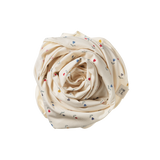 Rolled-up cream-colored wrap with small colorful flowers on a white background
