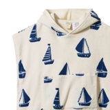 Detail view of hooded towel with blue sailboat pattern on a white background