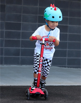 Child wearing a helmet, riding a red scooter