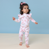 Child wearing a floral onesie against a blue background