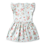Back view of Children's dress with floral and tea party pattern on a white background