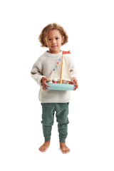 Child holding the TENDER LEAF Sailaway Boat