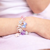 Child wearing the LAUREN HINKLEY Purple Butterfly Magic Charm Bracelet