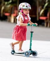 Child ridingMICRO SCOOTERS Mini Micro Deluxe Eco Scooter - Deep Green