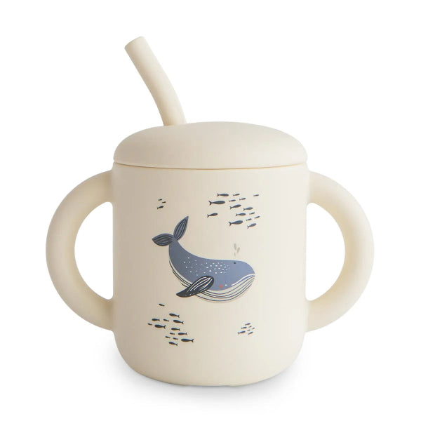 Children's sippy cup with whale design and straw on a white background