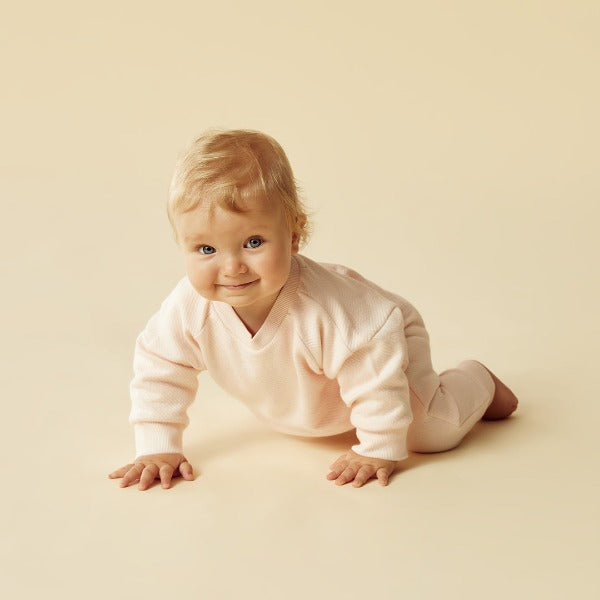 Baby crawling wearing WILSON + FRENCHY Pink Organic Quilted Sweat