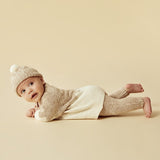 Baby lying on tummy wearing WILSON + FRENCHY Almond Fleck Knitted Hat