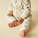 Baby wearing WILSON + FRENCHY Petit Garden Organic Zipsuit with Feet detail view of leg cuff