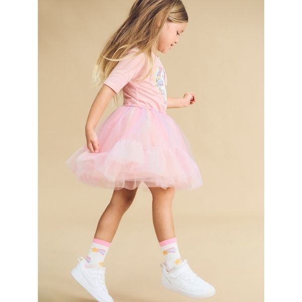 Side view of girl wearing HUXBABY Rainbow Unicorn Ballet Dress - studio shot