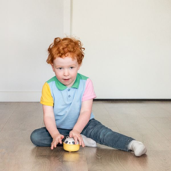 Child sitting on floor playing with TIGER TRIBE Rocking Rollers - Panda