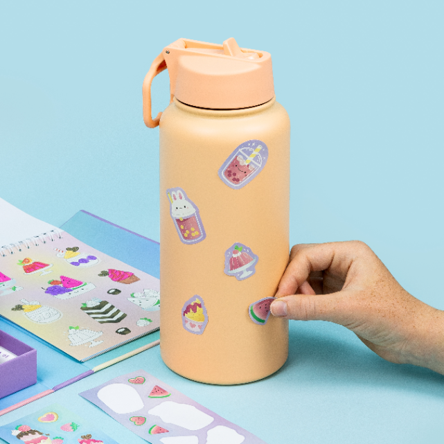 Putting stickers on a drink bottle
