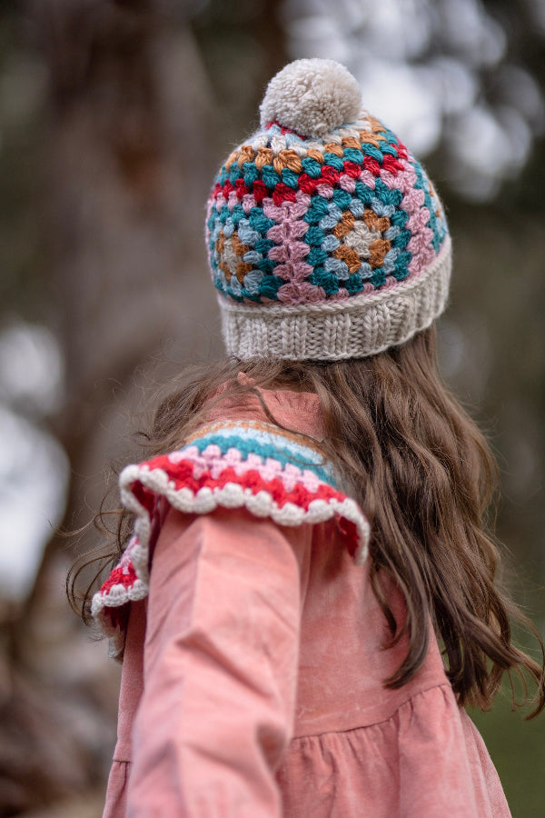 Back view of girl wearing the ACORN Woodstock Beanie Oatmeal