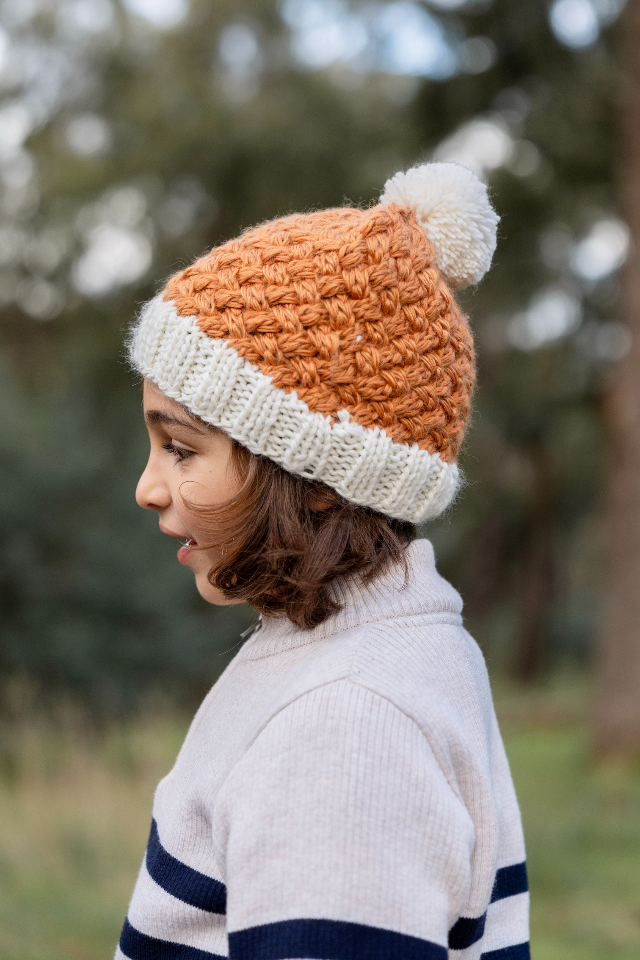 Side view of Child wearing ACORN Ripples Beanie Caramel