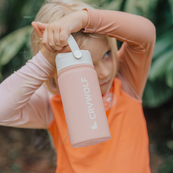 Child holding CRYWOLF Drink Bottle - Blush