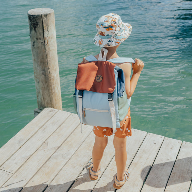 Child standing at pier wearing CRYWOLF Knapsack - Ocean Colour Block