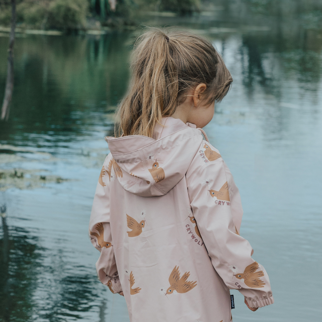 Back view of child wearing CRYWOLF Play Jacket Tui, Rosewood Rain Overalls and Dusty Pink Rain Boots