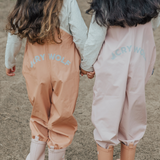 Detail back view of kids wearing CRYWOLF Rain Overalls Terracotta and Dusty Pink