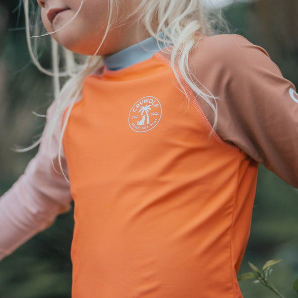 Detail view of logos on the CRYWOLF Rash Vest - Sunset Colour Block