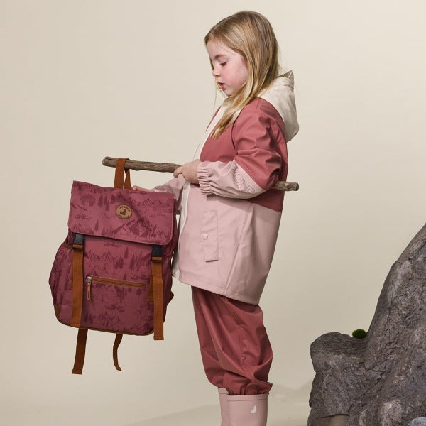 Side view of child wearing CRYWOLF Explorer Jacket Blush Rosewood and Rosewood Rain Overalls and Blush Rain boots