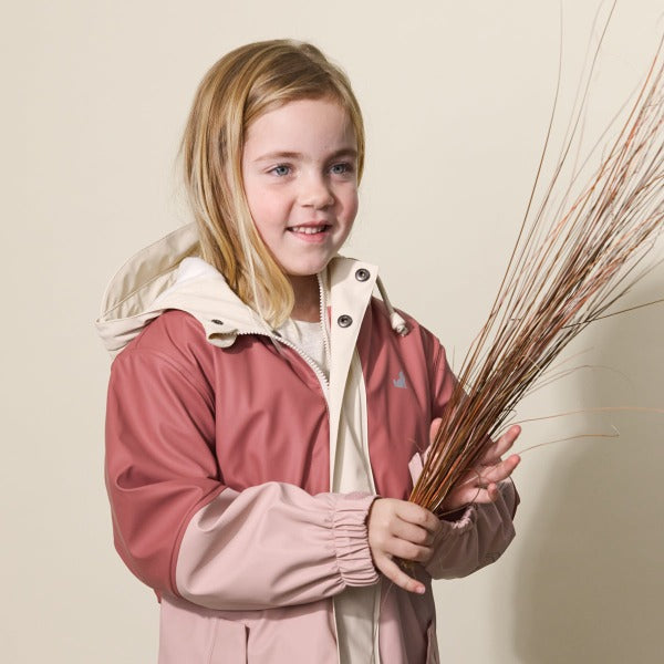 Studio shot of child wearing CRYWOLF Explorer Jacket Blush Rosewood