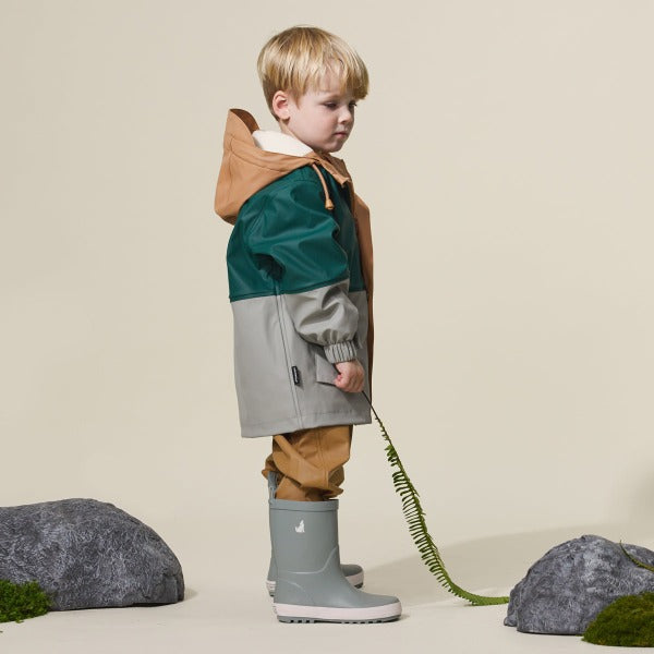 Side view of child wearing CRYWOLF Explorer Jacket Moss Forest and Moss Rain Boots